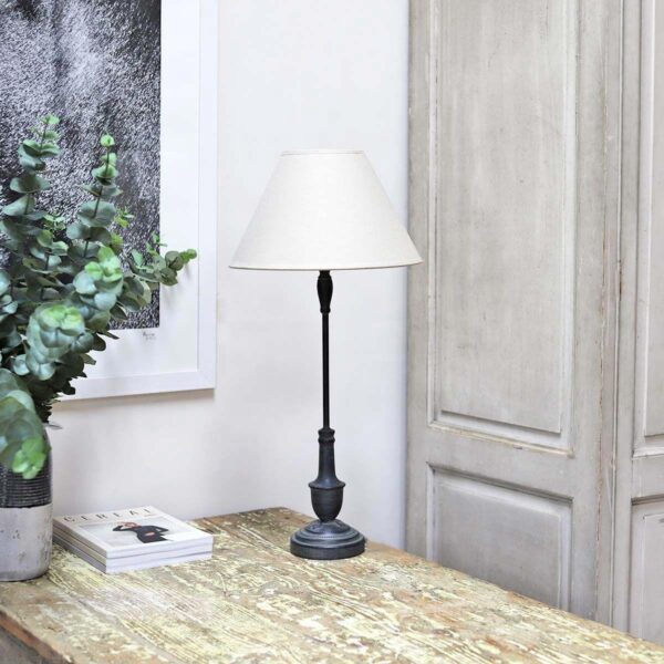 Dark Tall Metal Table Lamp with Linen Shade on a table.