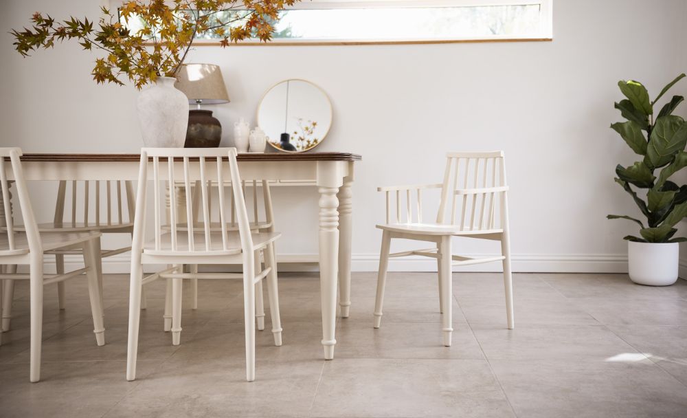 Traditional cream dining table with turned legs and oak top.