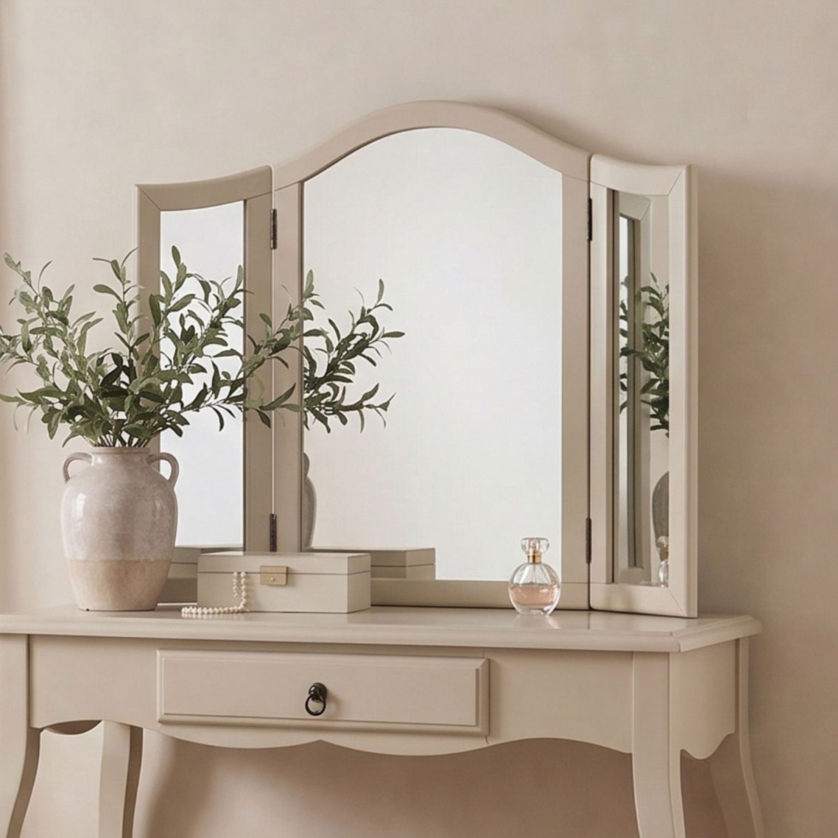 Romance tri fold vanity mirror featuring a gracefully arched top and a sturdy beige wooden frame atop a matching dressing table.